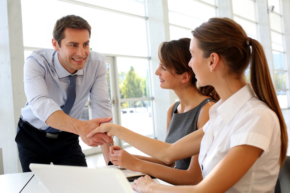 Salesman shaking hands to clients-1