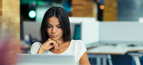 Portrait of a serious businesswoman using laptop in office-1